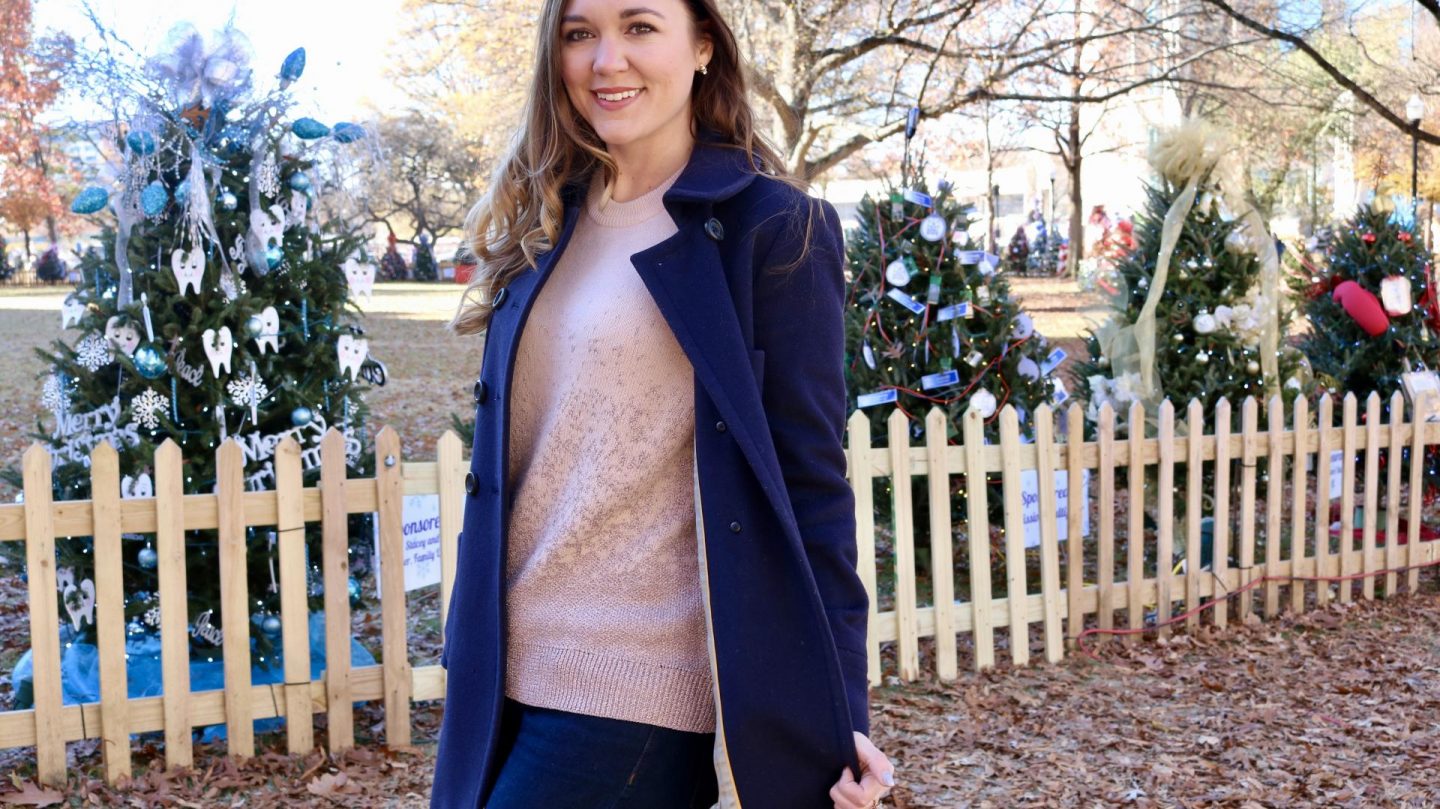 Katie in navy coat looking at camera