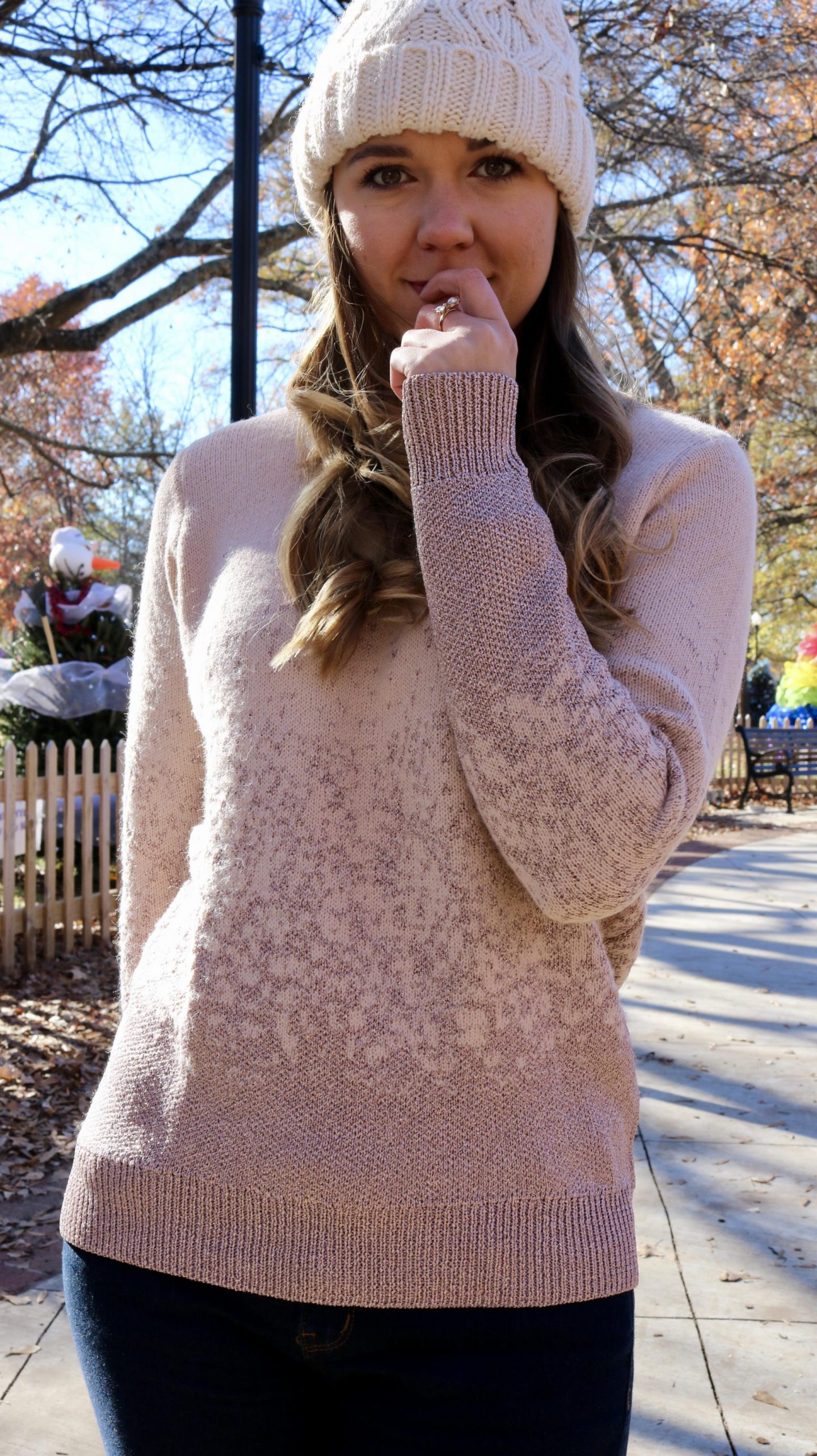 Katie in pink sweater looking at camera