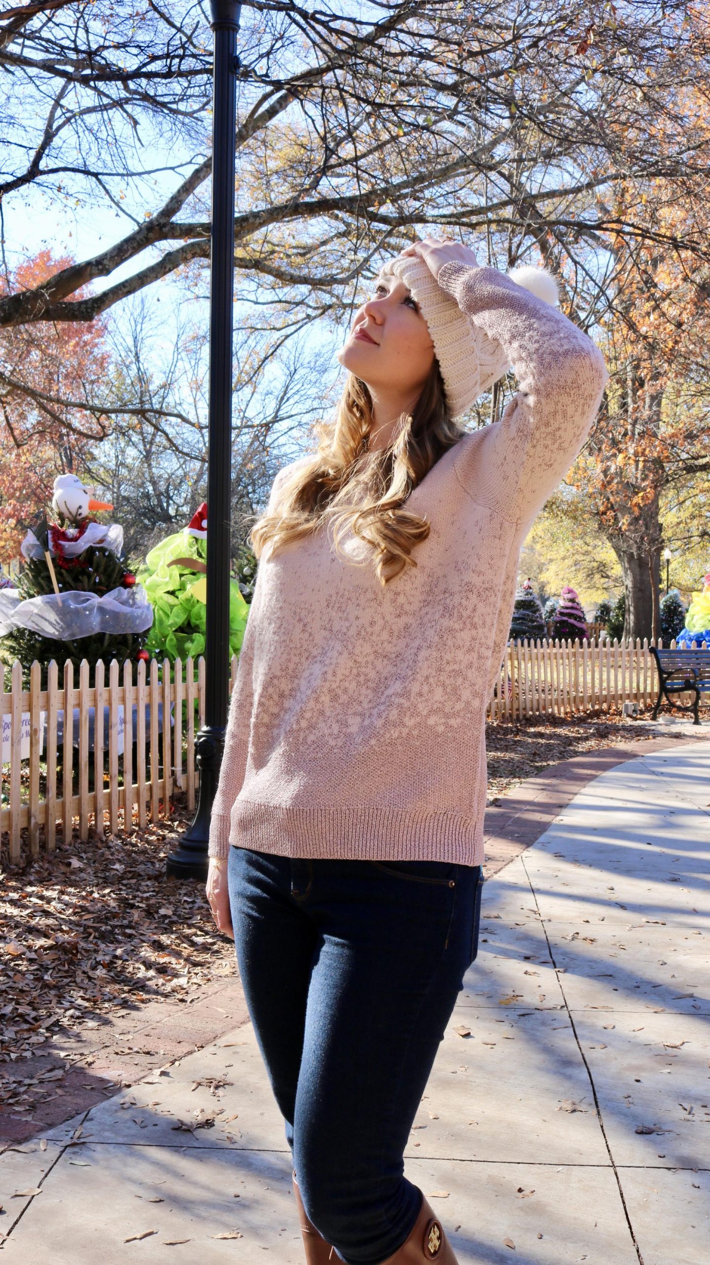 Katie in pink sweater looking up