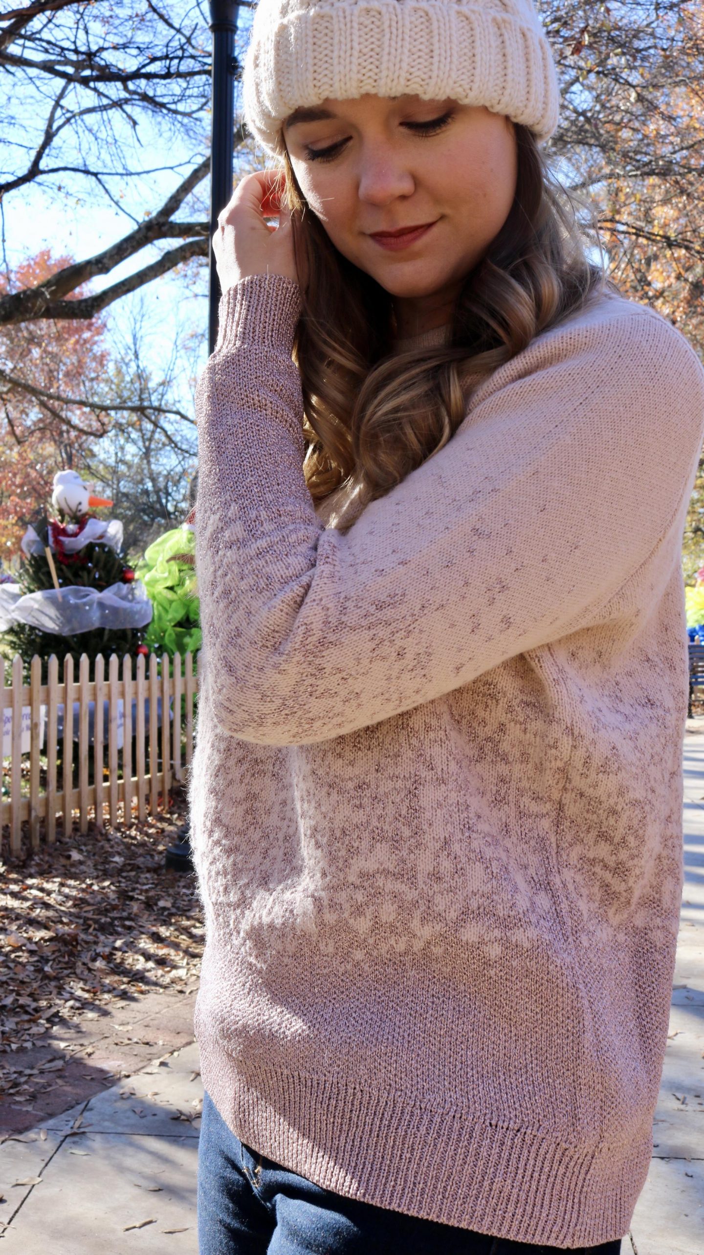 Katie in pink sweater closeup looking down