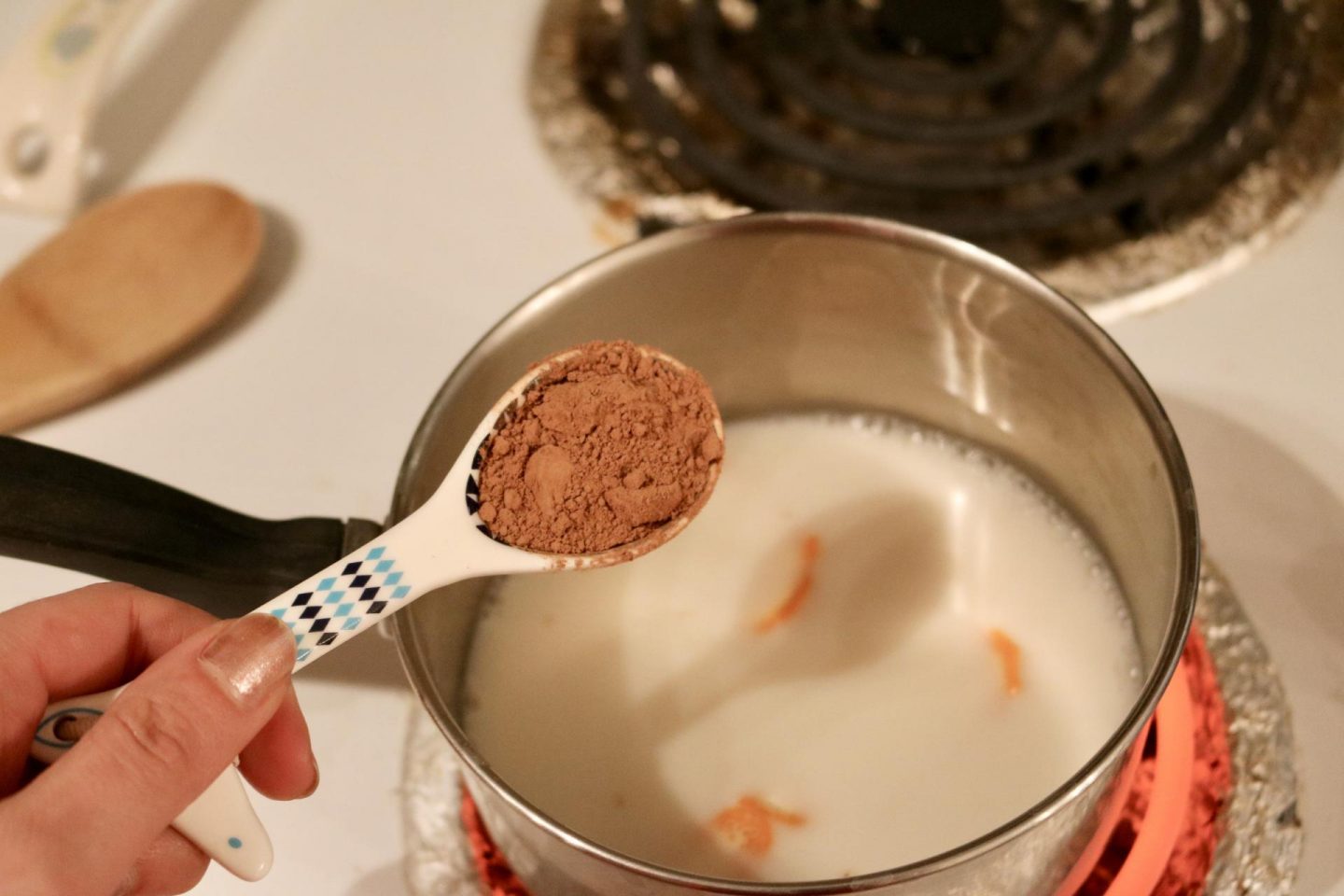 adding cocoa powder to the milk