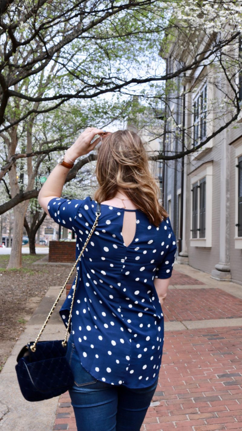 Katie in a navy polka dot shirt back